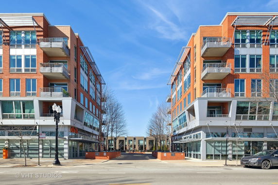 Front view of modern multi-story buildings with balconies and large windows.
