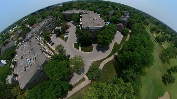Panoramic aerial view of a residential area with multiple apartment buildings and surrounding greenery.