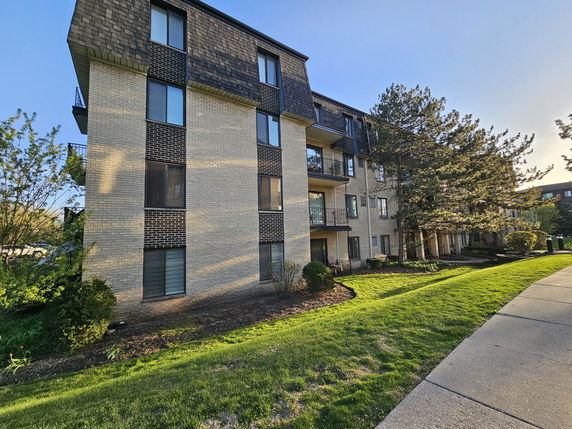 Front view of a multi-story residential building with balconies.