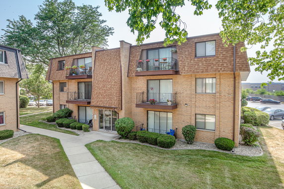 Front view of a multi-story residential building with balconies.