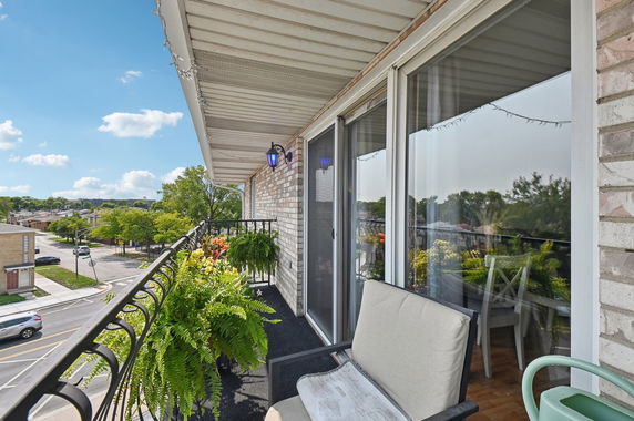Balcony view from a building showing a street and surrounding neighborhood.