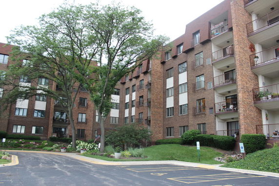 Front view of a multi-story brick apartment building.
