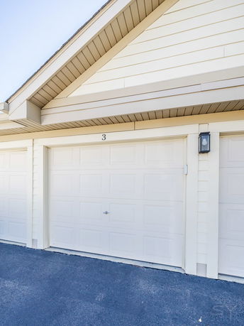 Front view of a house with a single garage door.