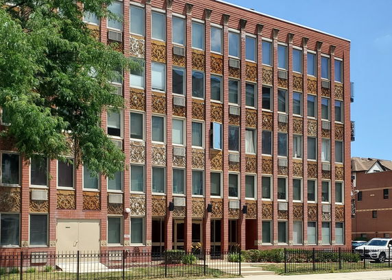 Front view of a multi-story building with decorative facade.