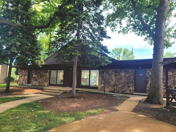 Front view of a single-story building with stone facade.