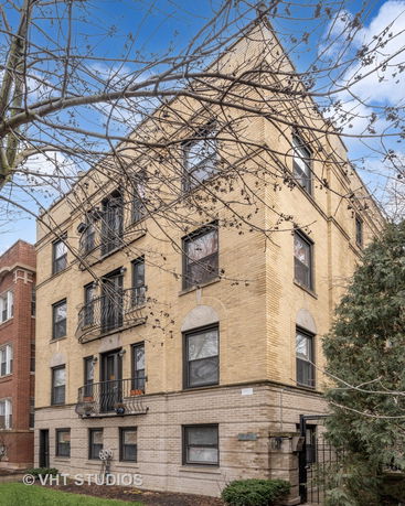 Front view of a multi-story brick apartment building.