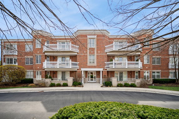 Front view of a brick building with multiple balconies.