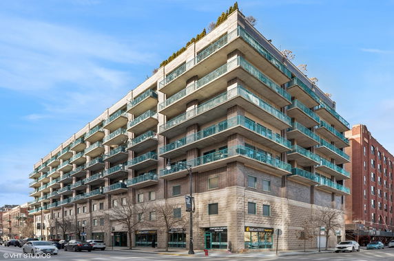 Front view of a multi-story building with balconies on each floor.