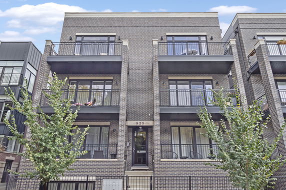 Front view of a multi-story residential building with balconies.