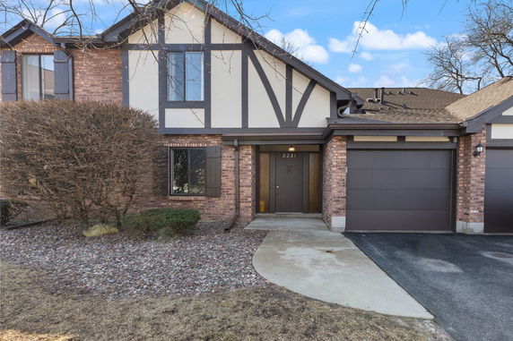 Front view of a house with a brick facade and attached garage.