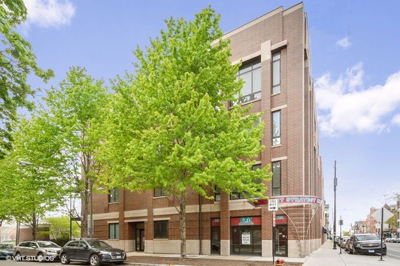 Front view of a multi-story commercial building with large windows.