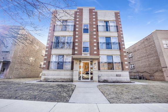 Front view of a multi-story brick apartment building