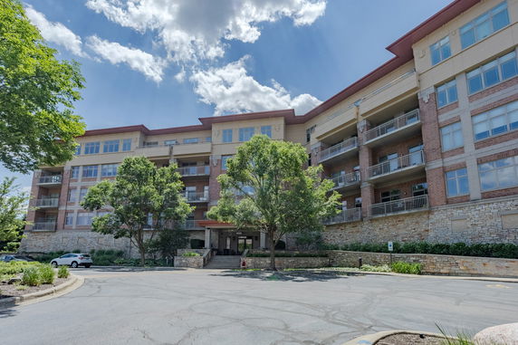 Front view of a multi-story residential building with balconies.