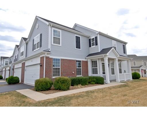 Front and side view of a two-story house with a double garage and a porch.