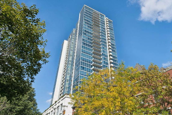 Elevated view of a high-rise building with a blue sky background.