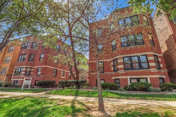 Front view of a multi-story brick apartment building.