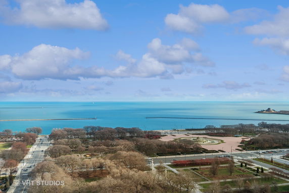 Wide-angle view of a large body of water and surrounding landscape.