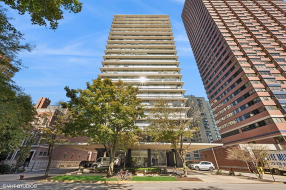 Front view of a multi-story apartment building with balconies.