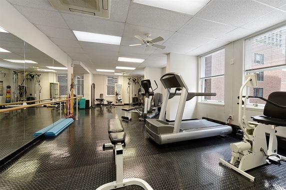 Interior view of a gym with treadmills and exercise equipment.
