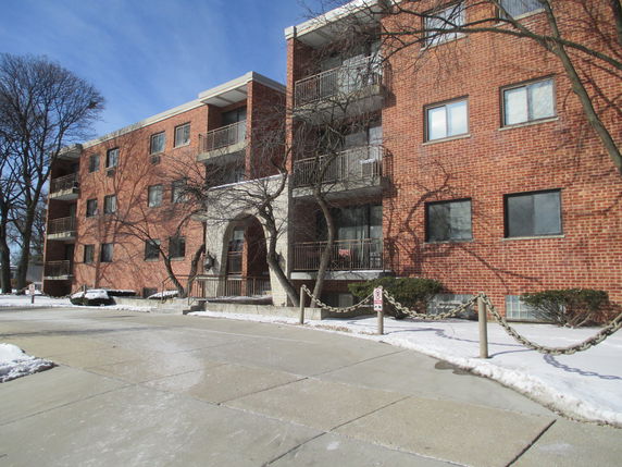 Front view of a multi-story brick residential building.