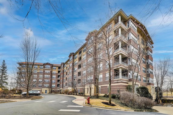 Front view of a multi-story brick apartment building.