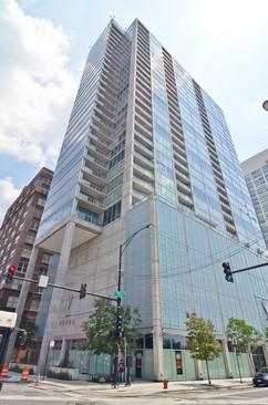 Front view of a modern high-rise building with glass exterior.