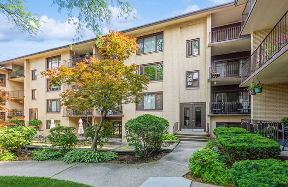 Front view of a multi-story residential building with balconies.