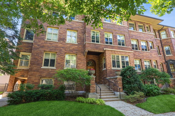 Front view of a multi-story brick apartment building.