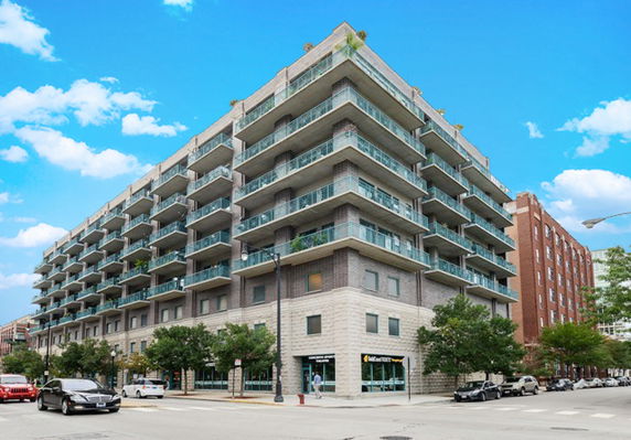 Front view of a multi-story residential building with balconies.