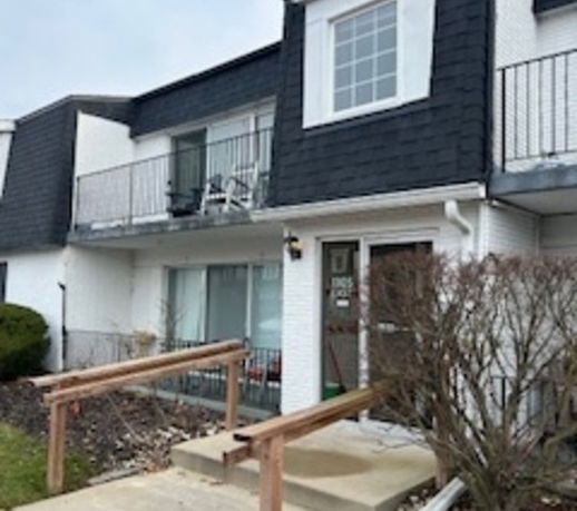 Front view of a two-story residential building with balconies.