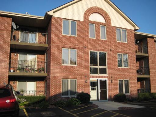 Front view of a multi-story brick apartment building