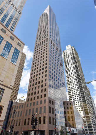 Front view of a tall skyscraper with a modern design.