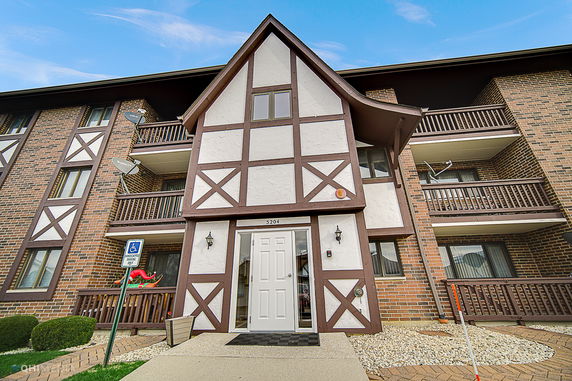 Front view of a multi-story building with half-timbered design and balconies.