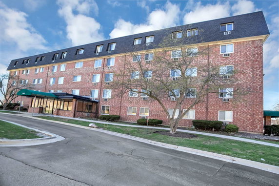 Front view of a multi-story brick apartment building.