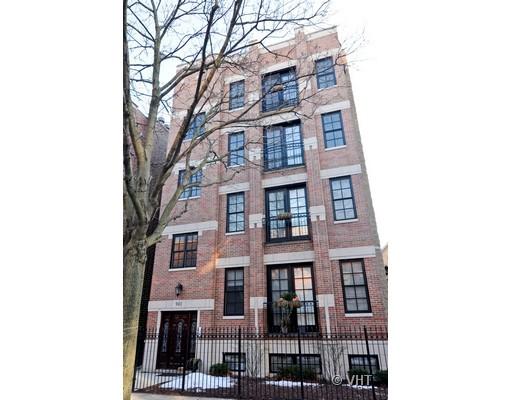 Front view of a multi-story brick apartment building with large windows and balconies.