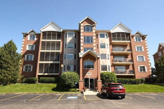 Front view of a multi-story residential building with balconies.