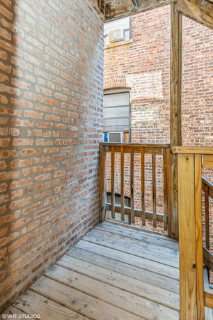 View from a wooden balcony overlooking surrounding brick buildings.