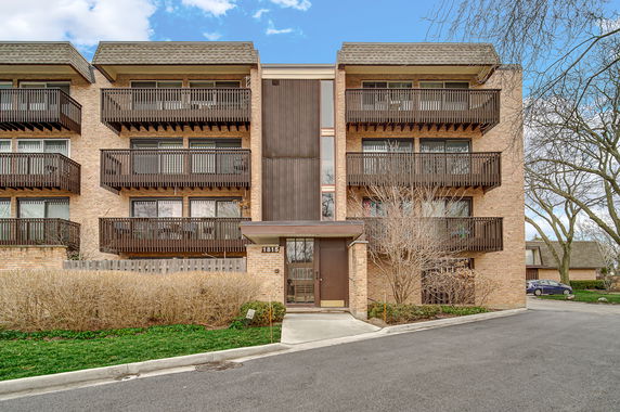 Front view of a multi-story building with balconies.