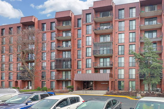 Front view of a multi-story residential building with balconies.