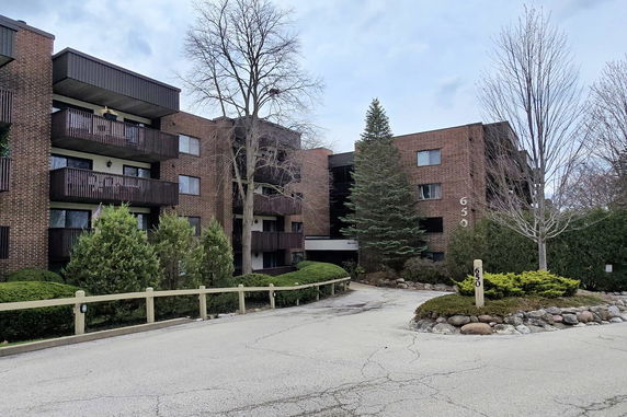 Front view of a multi-story apartment building with balconies.