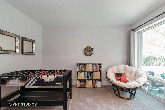 Indoor play area with foosball table, dartboard, and cozy seating.