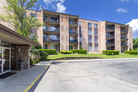 Front view of a multi-story apartment building with balconies.