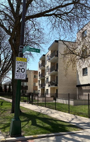 Front view of a multi-story apartment building with balconies.