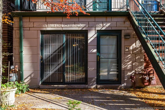 Front view of a building with a staircase and two doors.