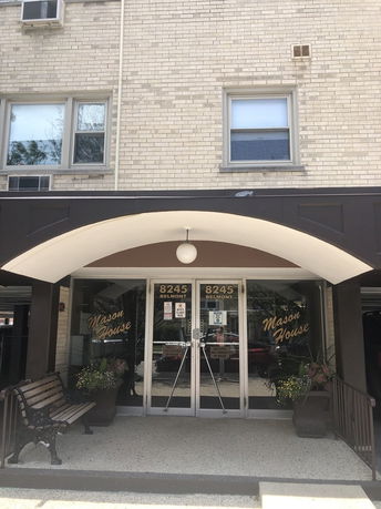 Front view of a multi-story building entrance with glass doors labeled 'Mason House'.
