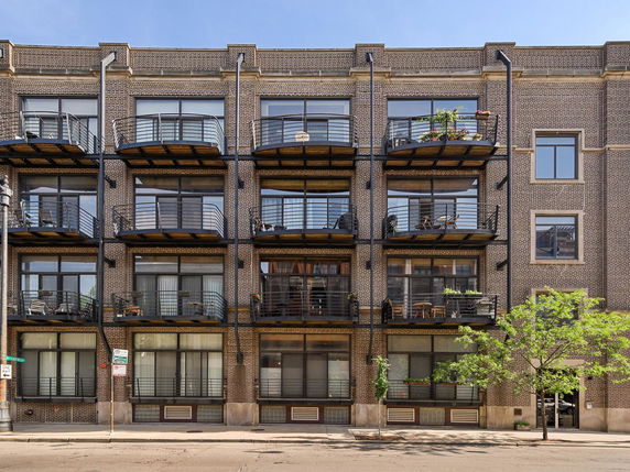 Front view of a multi-story building with balconies.