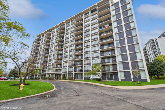Front view of a multi-story apartment building with balconies.