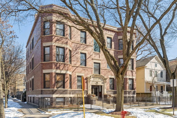 Front view of a three-story brick apartment building.