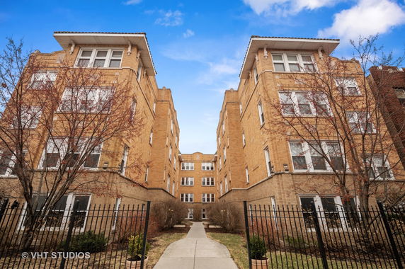Front view of a multi-story brick building with symmetrical architecture.