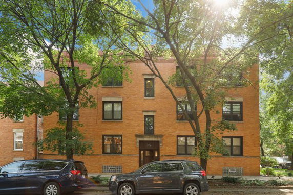 Front view of a three-story brick apartment building.